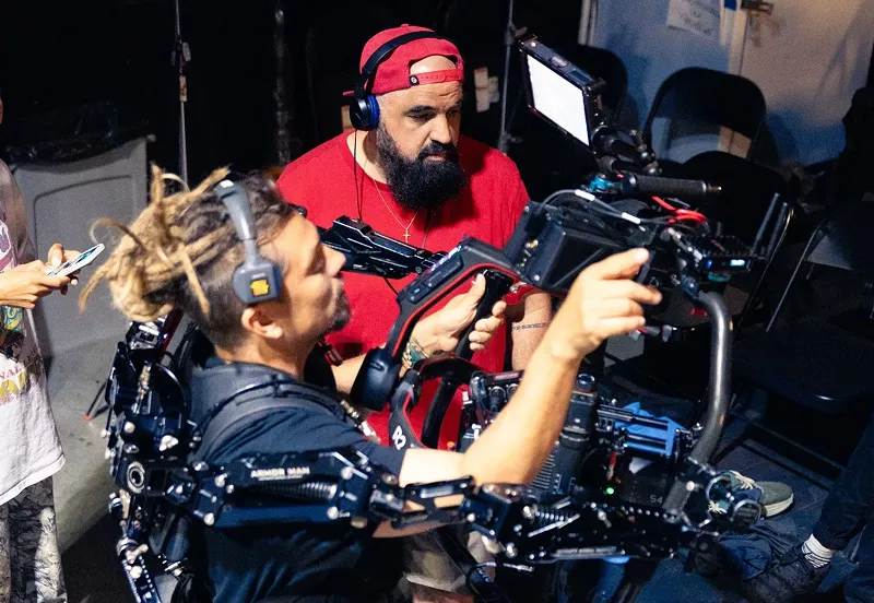 Image: two filmmakers behind the scenes on a video shoot