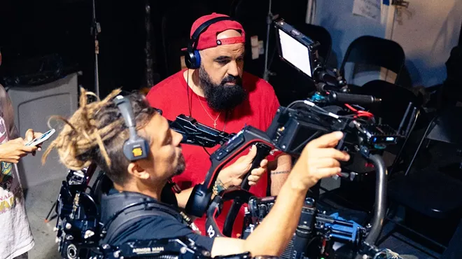 two filmmakers behind the scenes on a video shoot