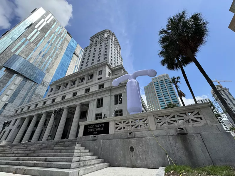 Image: A large grey balloon in the shape of an intrauterine outside a Miami courthouse building