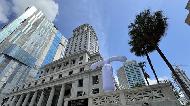 A large grey balloon in the shape of an intrauterine outside a Miami courthouse building