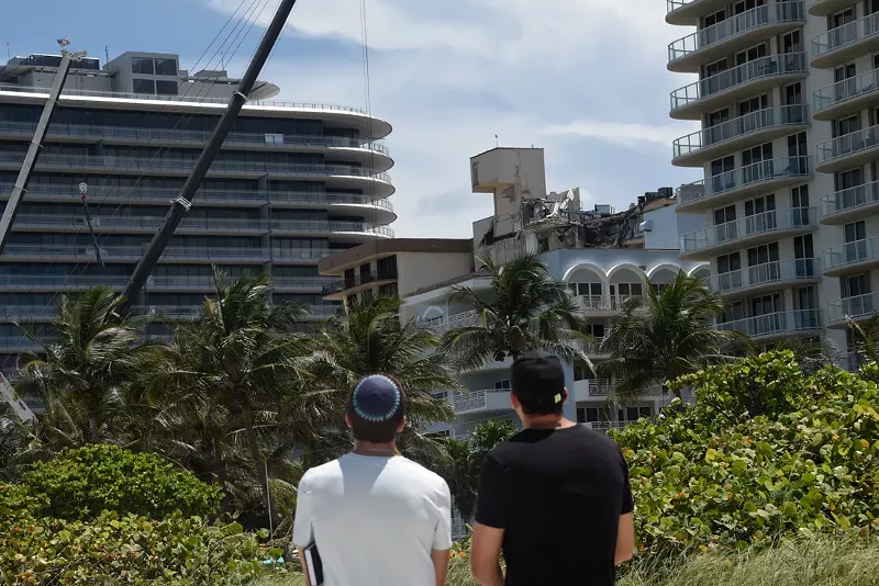 Image: Onlookers on Surfside Breach watch the broken remains of the Champlain Towers South condo before it was torn down this past Sunday.