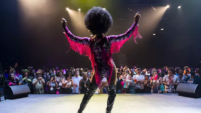 back view of a drag queen performing onstage