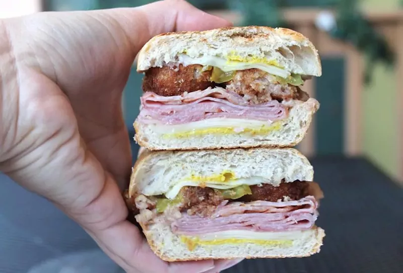 Image: A hand holding a sandwich