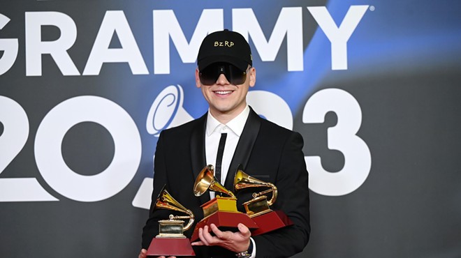 Bizarrap posing with three Latin Grammy trophies in his hands