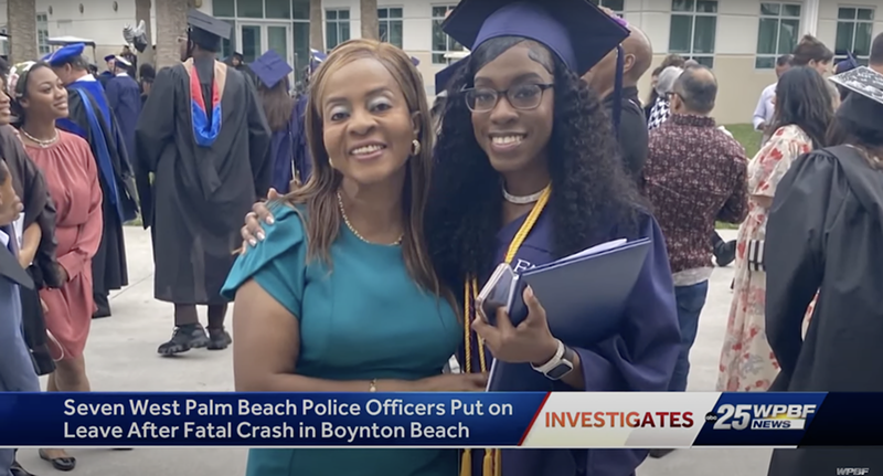 Image: A woman stands next to her daughter, who is donning a cap and gown on graduation day.