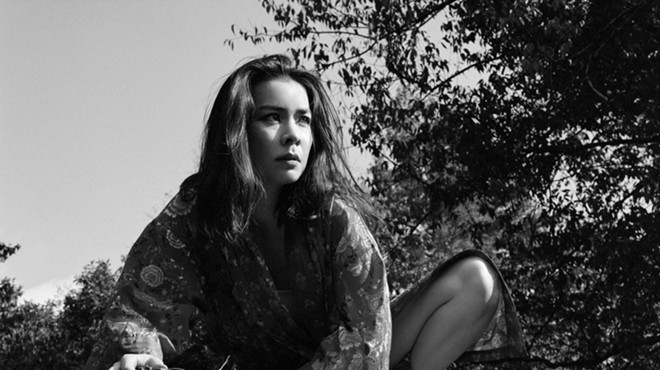 Mitski in front of a tree