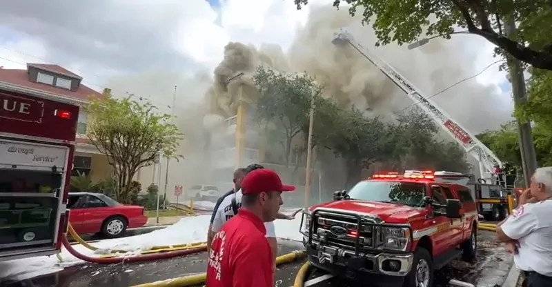 Image: Smoke billows from the Temple Court Apartments in Miami as firefighters scramble to fight the blaze