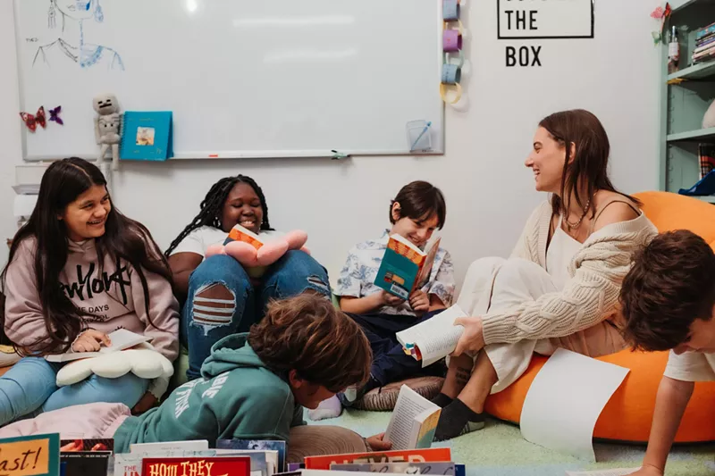 Image: A teacher reads to smiling students at Primer Health District microschool.