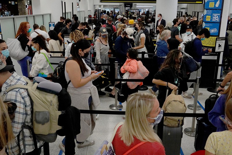 Travelers are herded through a security checkpoint at Miami International Airport.