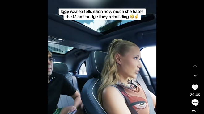 Screenshot of a TikTok video showing livestreamer N3on in the back of a car being driven by rapper Iggy Azalea. Text overlayed over the image reads, "Iggy Azalea tells N3on how much she hates the Miami bridge they're building 🤣✌️"