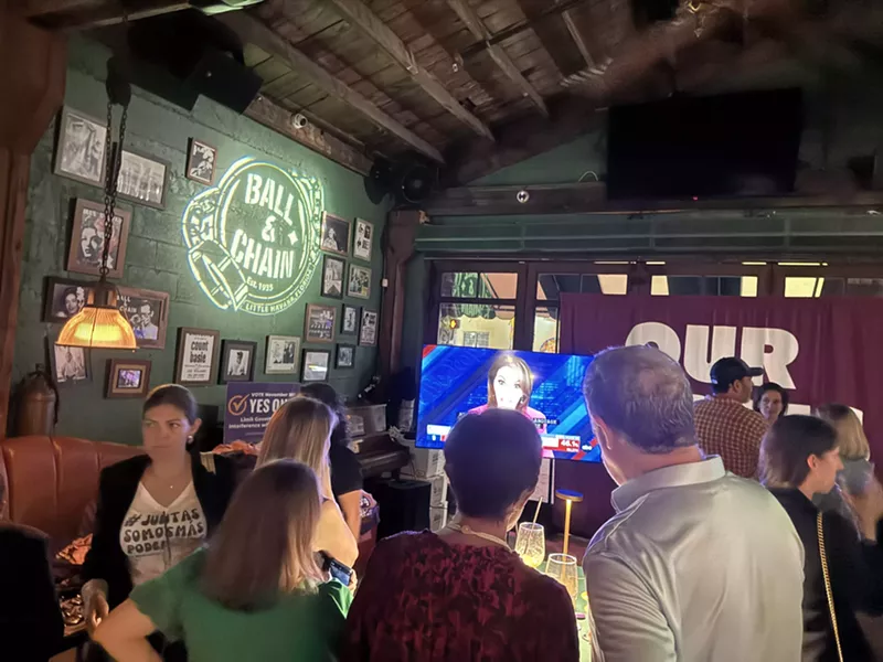 Image: People watching MSNBC during election watch party at Ball & Chain.
