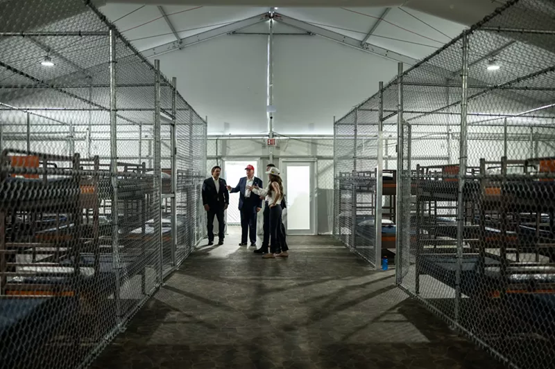 Image: President Donald Trump participates in a walking tour of the immigration detention center, Alligator Alcatraz.