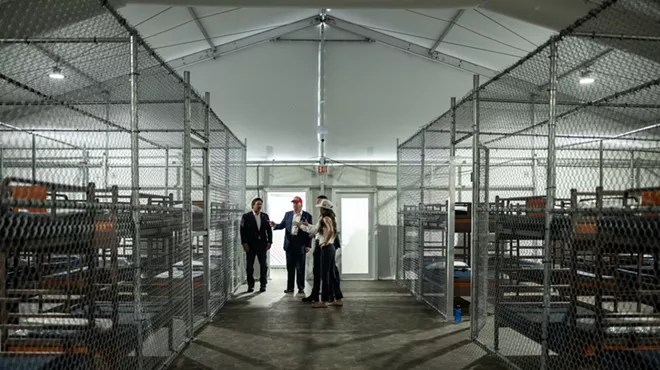 President Donald Trump participates in a walking tour of the immigration detention center, Alligator Alcatraz.