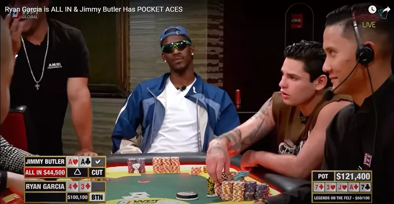 Image: Jimmy Butler in sunglasses and backwards cap at a high stakes poker table