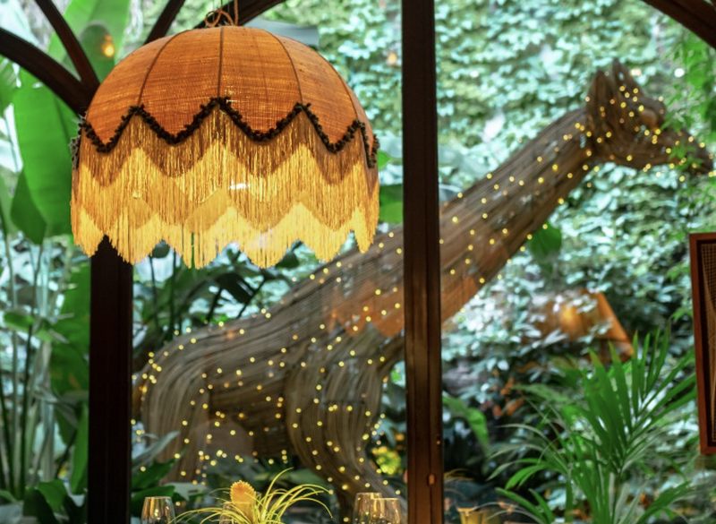 Image: The dining room of Amazónico in Madrid looks out to a sculpture of a giraffe
