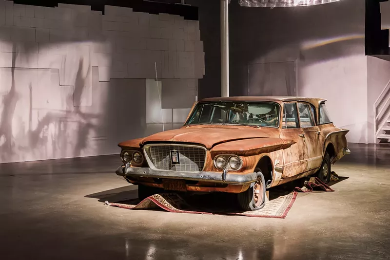 Image: "The patience of ordinary things" art installation features a rusted car