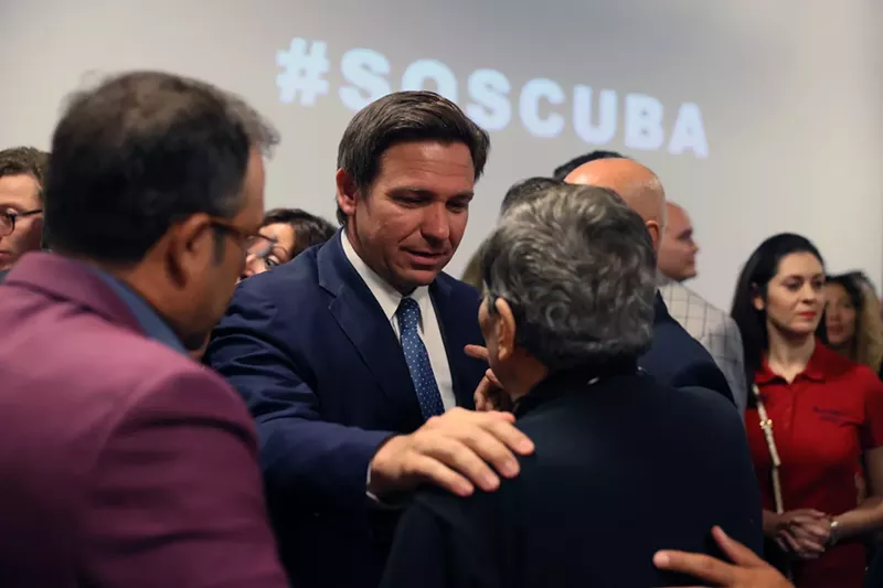 Image: Florida Gov. Ron DeSantis greets people after holding a roundtable discussion about the uprising in Cuba at the American Museum of the Cuba Diaspora on July 13, 2021, in Miami.