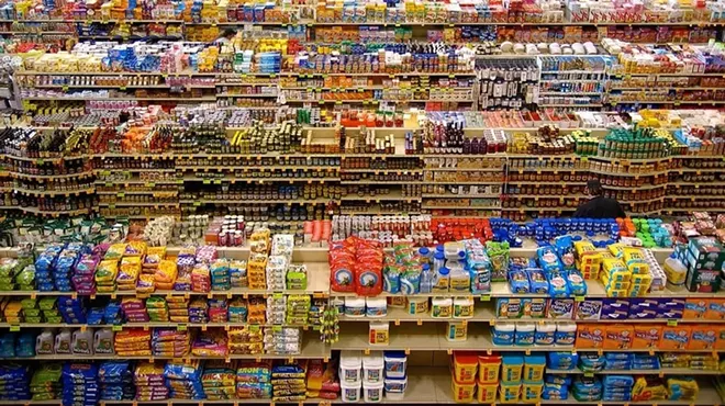 Groceries sit on aisles of a store.