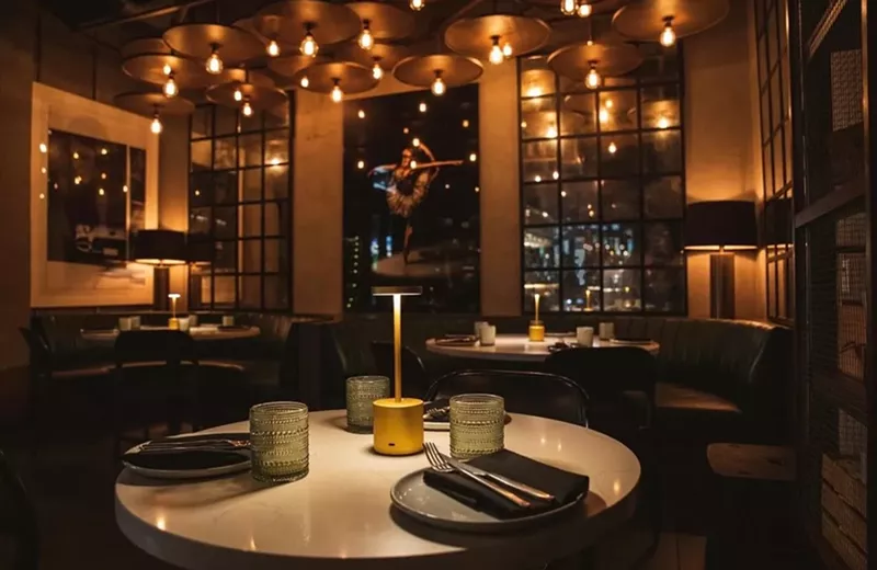 Image: Picture of a table at a restaurant with dim lights.