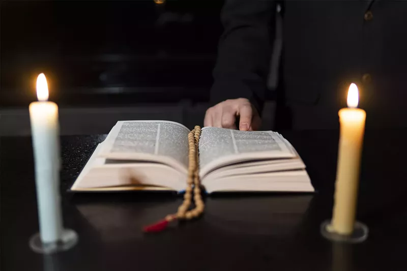 Image: A bible surrounded by two candles