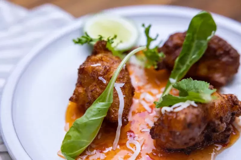 Image: These coconut shrimp hush puppies with Thai dipping sauce are available at Norman Van Aken's newly reimagined Norman's in Orlando.