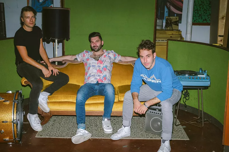Image: The members of the Magic City Hippies sitting on a couch