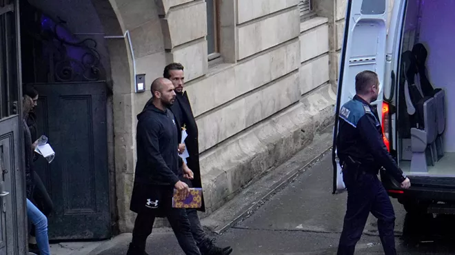 Social media influencer Andrew Tate and his brother walk out of court in Romania