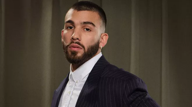 headshot of Manuel Turizo wearing a dress shirt and blazer