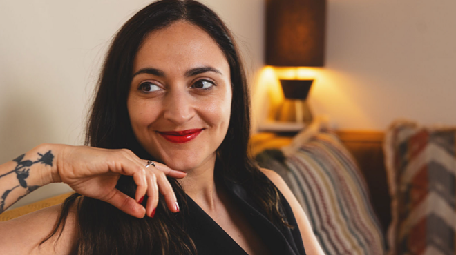 Headshot of a journalist smiling