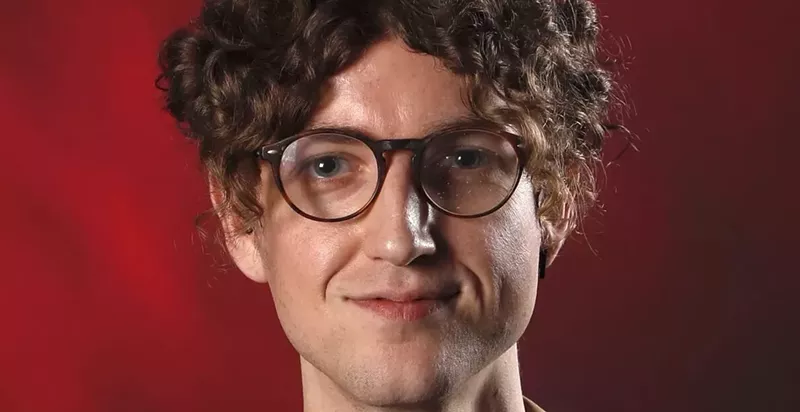 Image: A journalist's headshot.