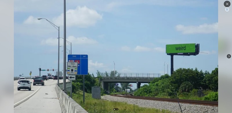 A puke-green sign off Tenth Avenue and I-95 with the word "weird" appeared in Palm Beach County.