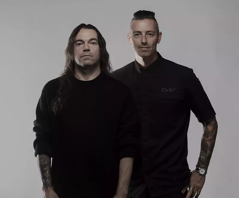 Image: Two men posing for the camera wearing black.