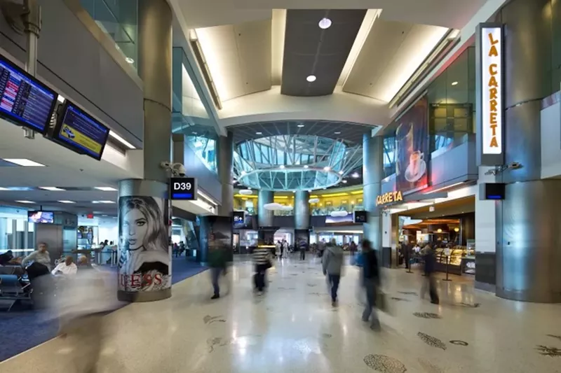 Image: Passengers walk through Concourse D at Miami International Airport.