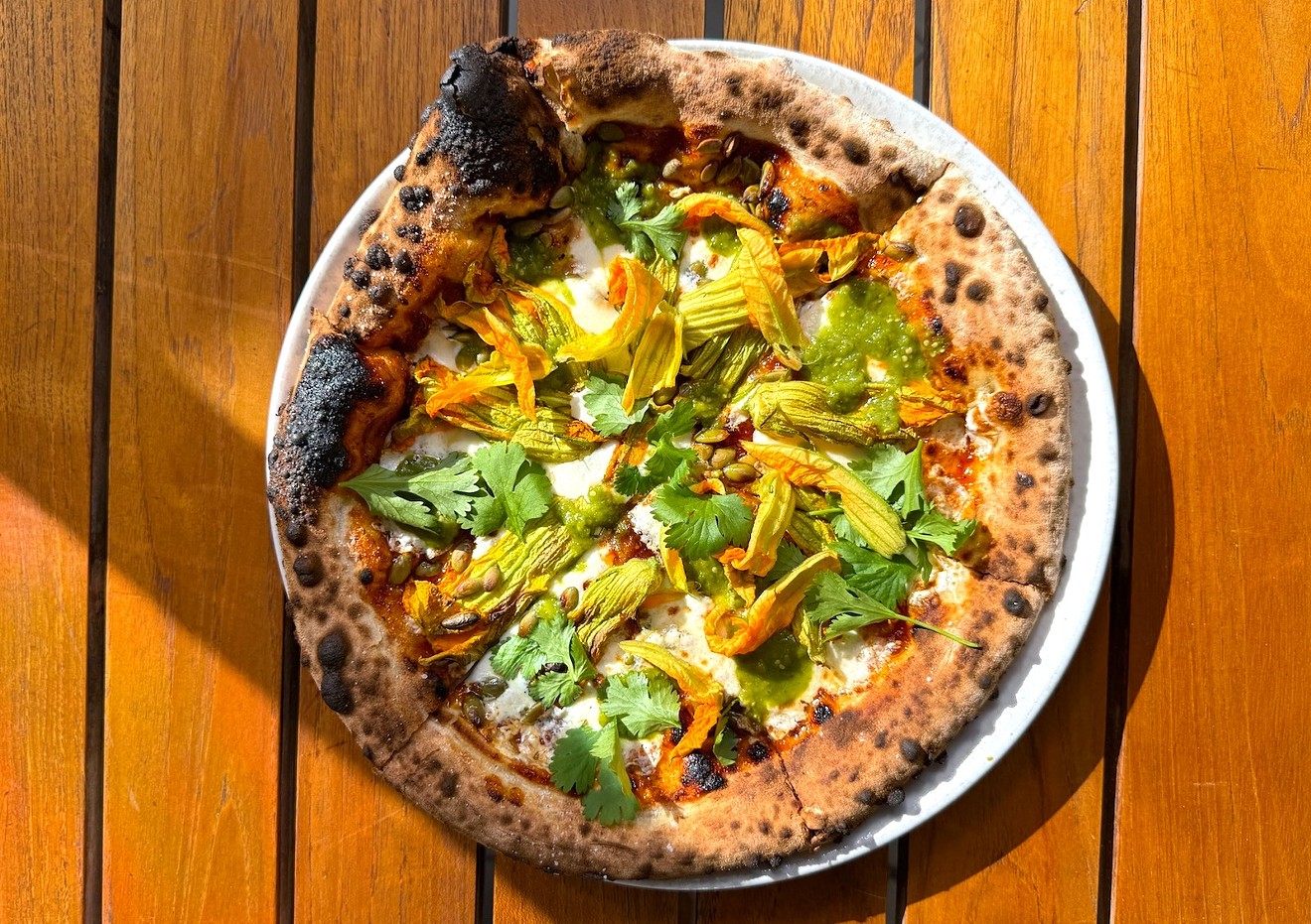 The Oaxacan pizza will be offered as part of the Masienda dinner topped with squash blossoms, quesillo, salsa, and pumpkin seeds.