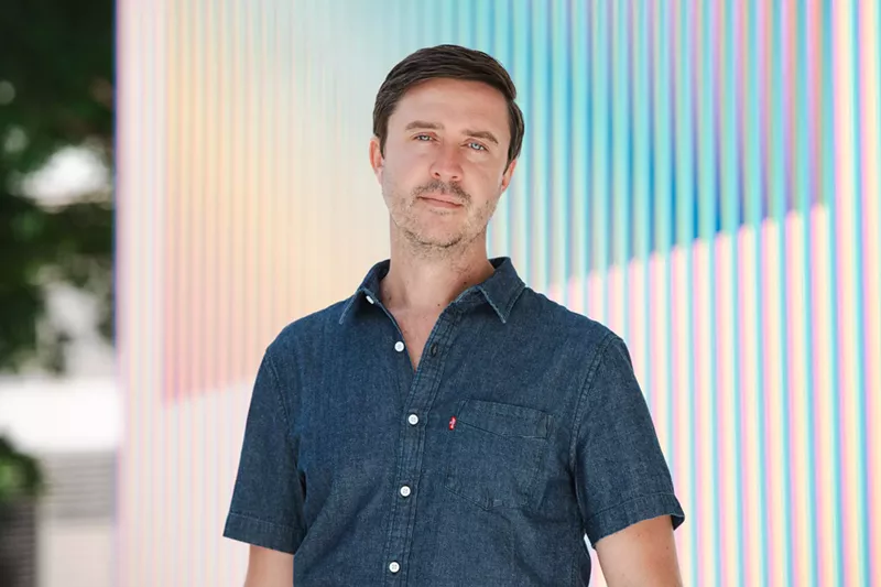 Image: Portrait of James Woolley in a blue button-up shirt