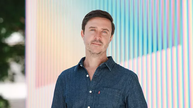 Portrait of James Woolley in a blue button-up shirt