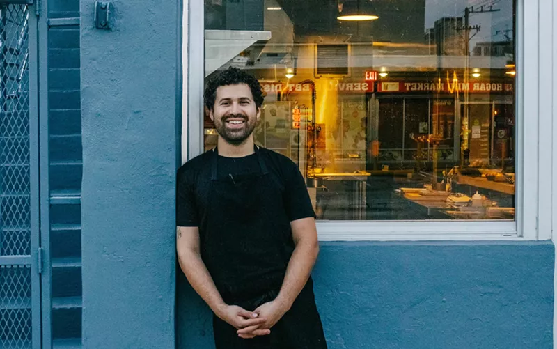Image: Man in front of building