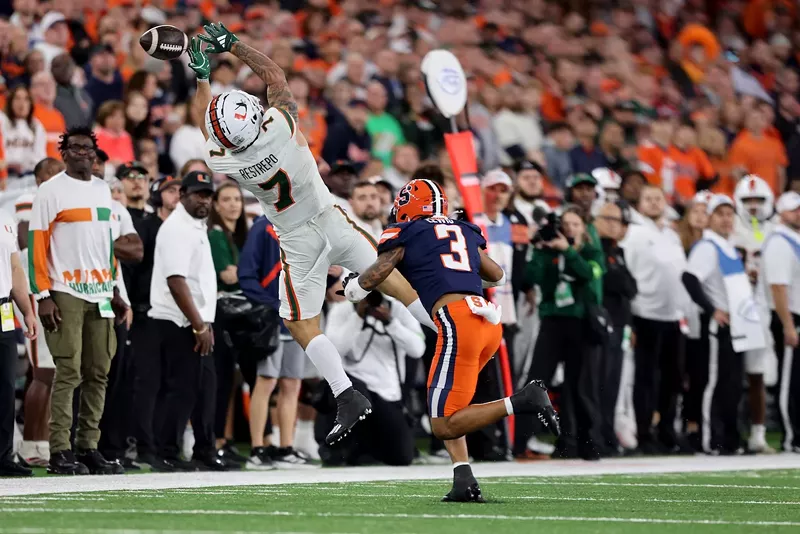 Image: Xavier Restrepo #7 of the Miami Hurricanes attempts to catch a pass during the fourth quarter against the Syracuse Orange at JMA Wireless Dome on November 30, 2024, in Syracuse, New York.