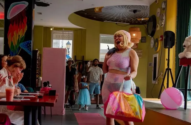 Image: A woman performs in front of judges at a Barbie-themed fashion show