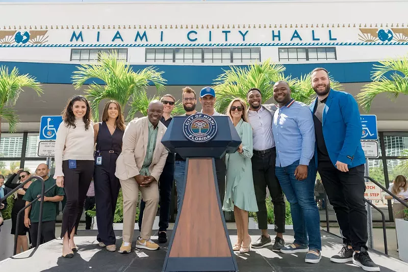 Image: Mayor Francis Suarez stands at the podium outside Miami City Hall with Elian Asparouhov of Founders Fund, Keith Rabois from Khosla Ventures, Jack Abraham of Atomic, Erick Gavin of Venture Miami, Ja'dan Johnson from Miami Hack Week, Maria Derchi Russo of Refresh Miami, and Avery Akkineni from VaynerX.
