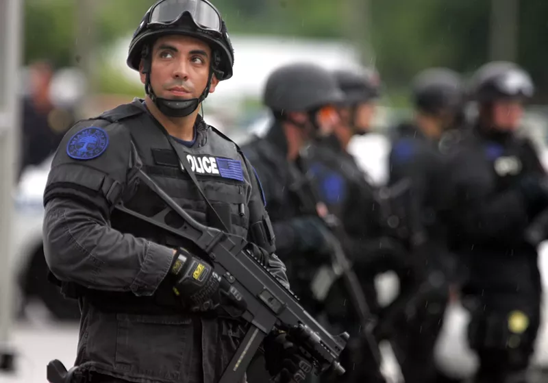 Image: A Miami Police Department SWAT team member on the scene of a drug raid in Liberty City in 2006.