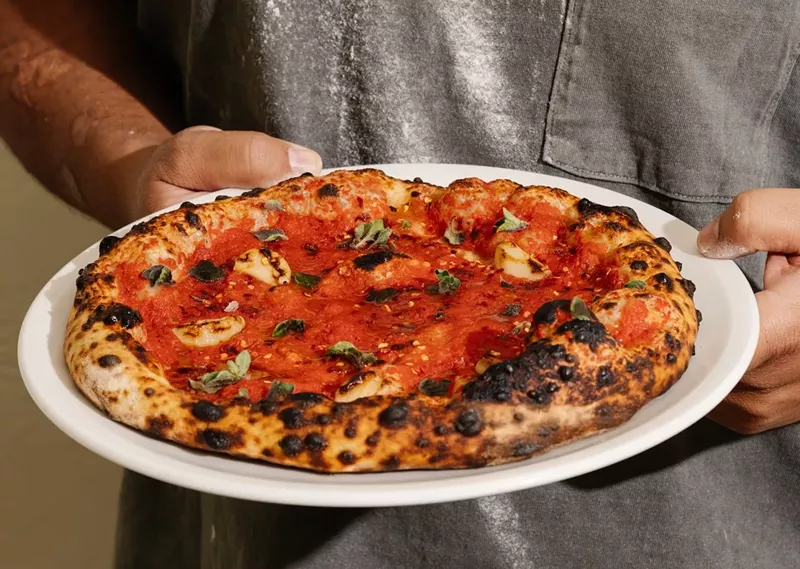 Image: La Natural’s sourdough pies are fermented for 48 hours and fired in a wood-burning oven behind the bar.