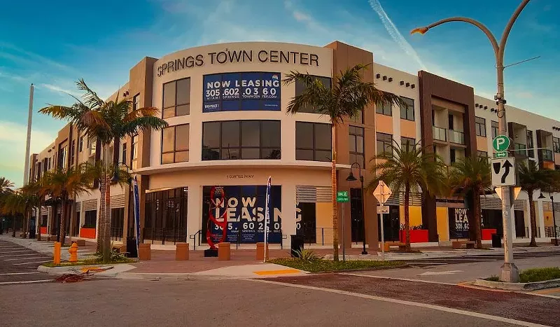Image: The front entrance to a newly built, modern-look mixed-use in Miami Springs