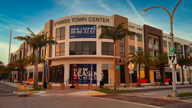 The front entrance to a newly built, modern-look mixed-use in Miami Springs
