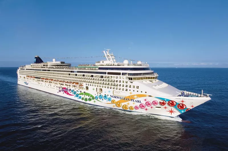 Image: A Norwegian Pearl cruise ship floats across the ocean