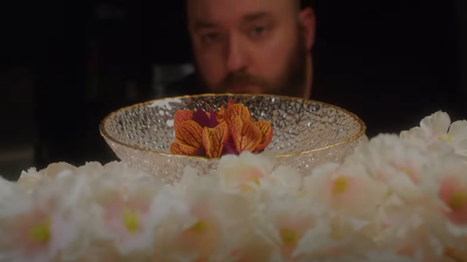 Jacob Bickelhaupt looking at a dish at his restaurant, Konro.