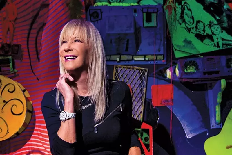 Image: Mindy Shrago smiles against a colorful backdrop
