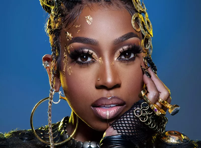 Image: Portrait of Missy Elliott against a blue background