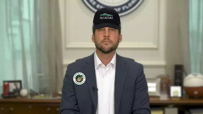 Florida Attorney General James Uthmeier wearing an alligator alcatraz hat and an alligator alcatraz button