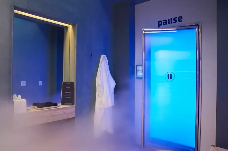 Image: a steamy treatment room with blue lighting inside a spa